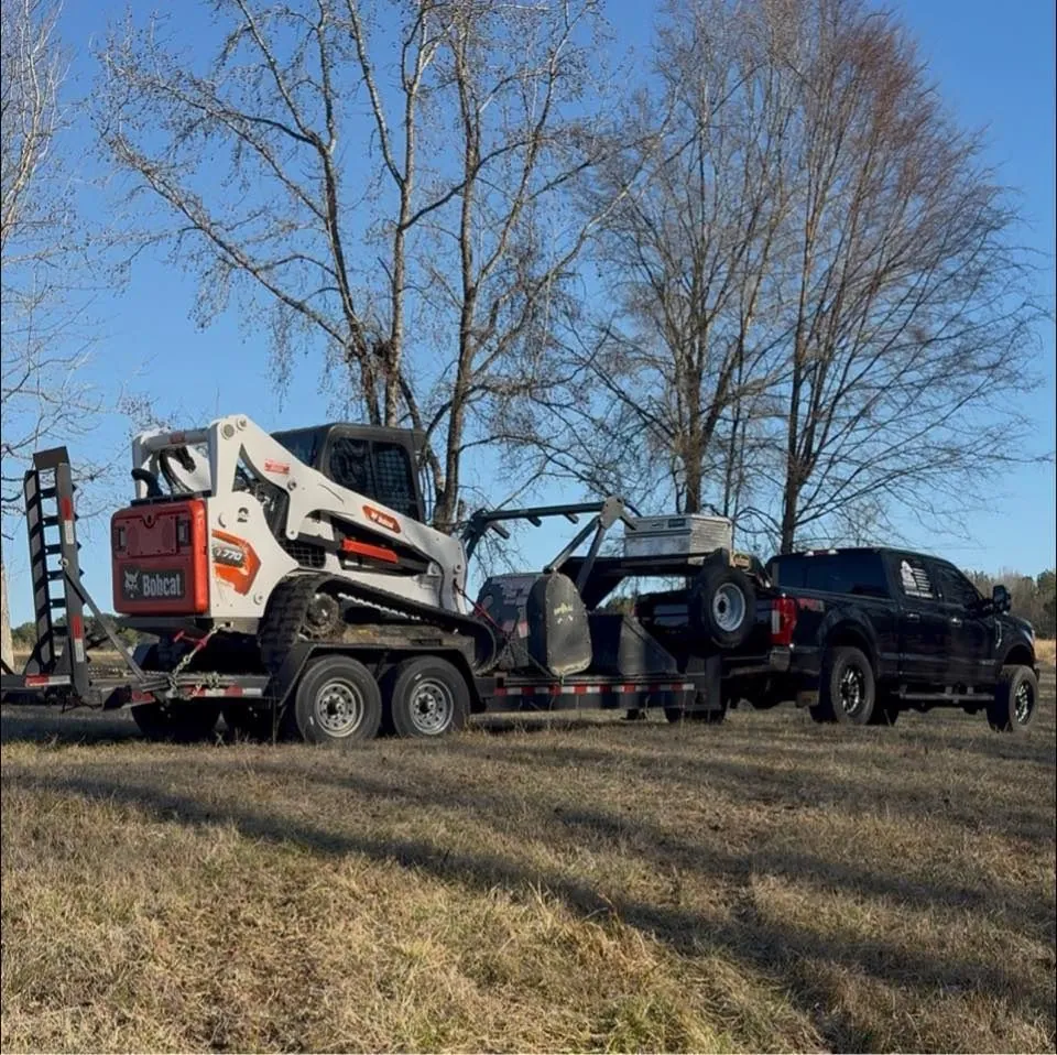 BrushKat truck and trailer carrying its tracked machine